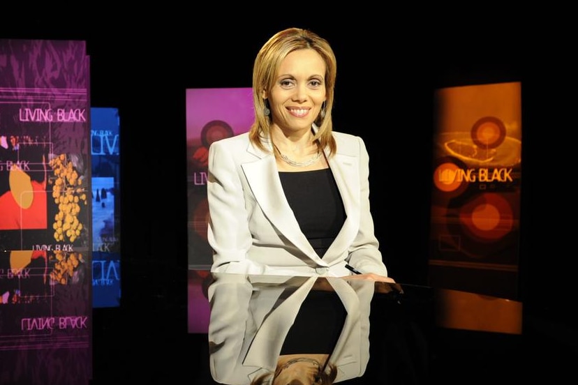 A woman sits at a desk.