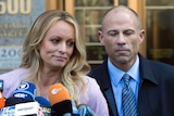 Adult film actress Stormy Daniels stands with her lawyer Michael Avenatti