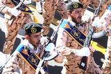 Iranian armed forces members march in a military parade
