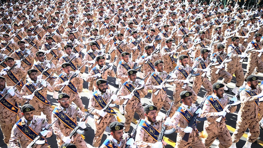 Iranian armed forces members march in a military parade