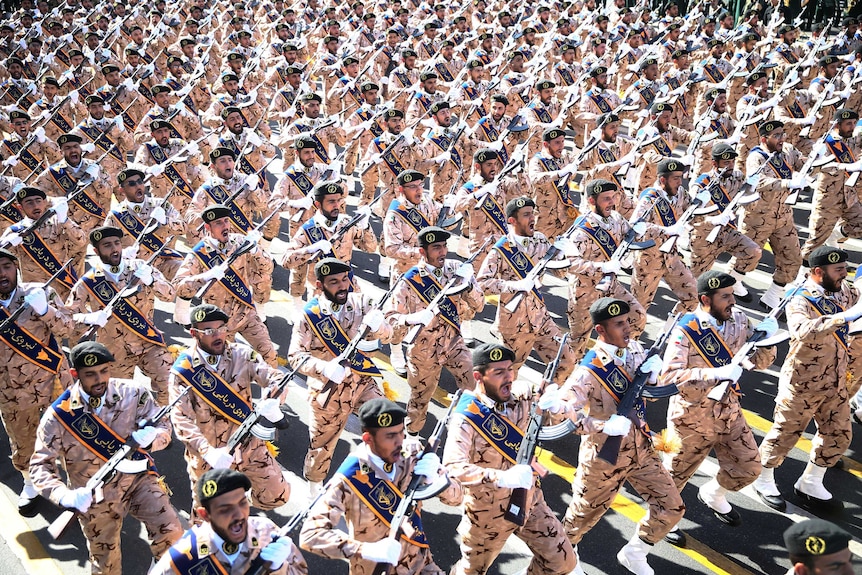 Iranian armed forces members march in a military parade