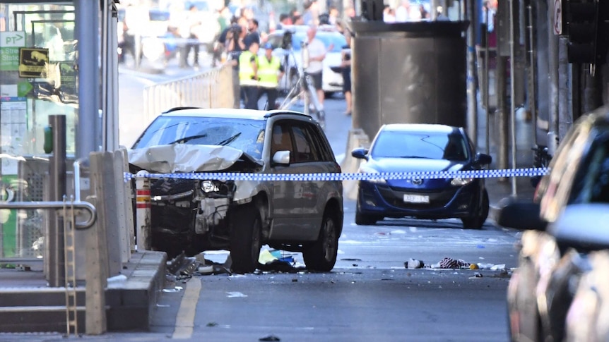 A damaged vehicle is seen on Flinders Street, in Melbourne.