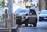 A damaged vehicle is seen on Flinders Street, in Melbourne.