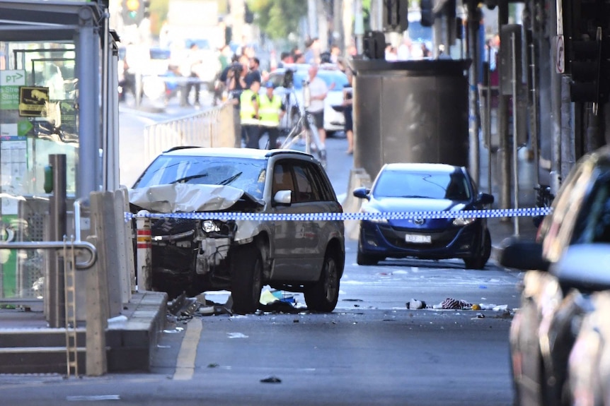 A damaged vehicle is seen on Flinders Street, in Melbourne.