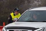 Police scrutinise a driver at George Chaffey Bridge in Buronga, NSW.