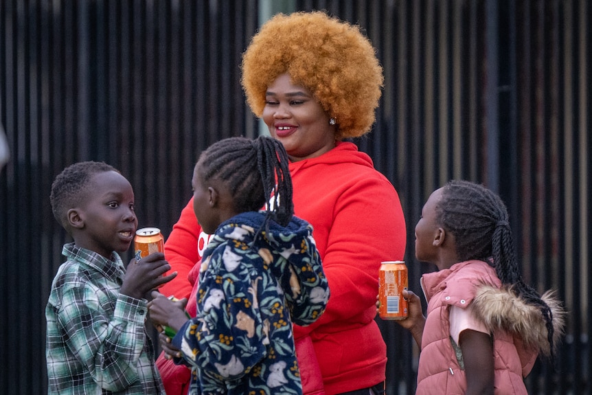 An African mother and her kids at soccer game