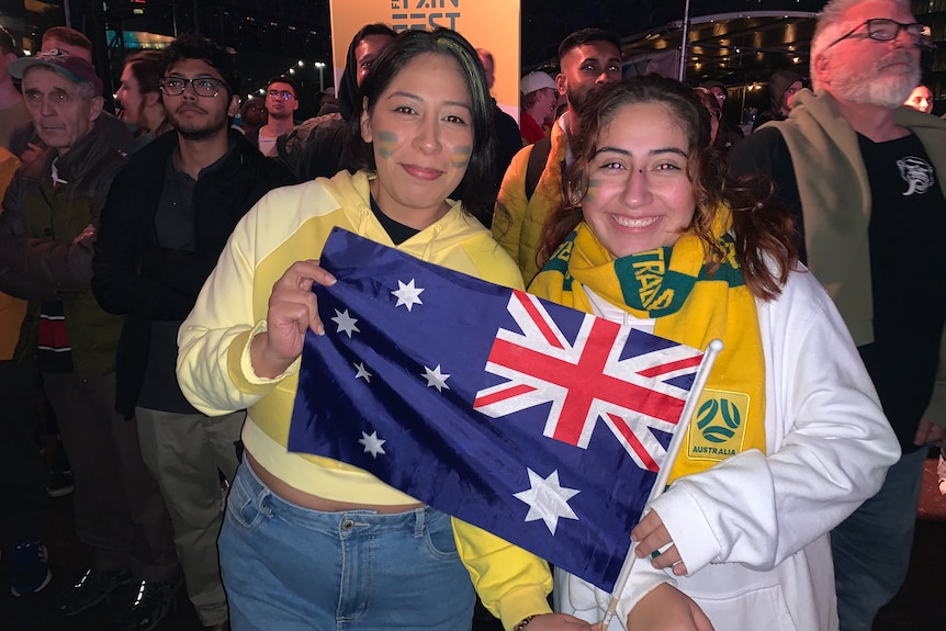 two young women holding an australian flag 