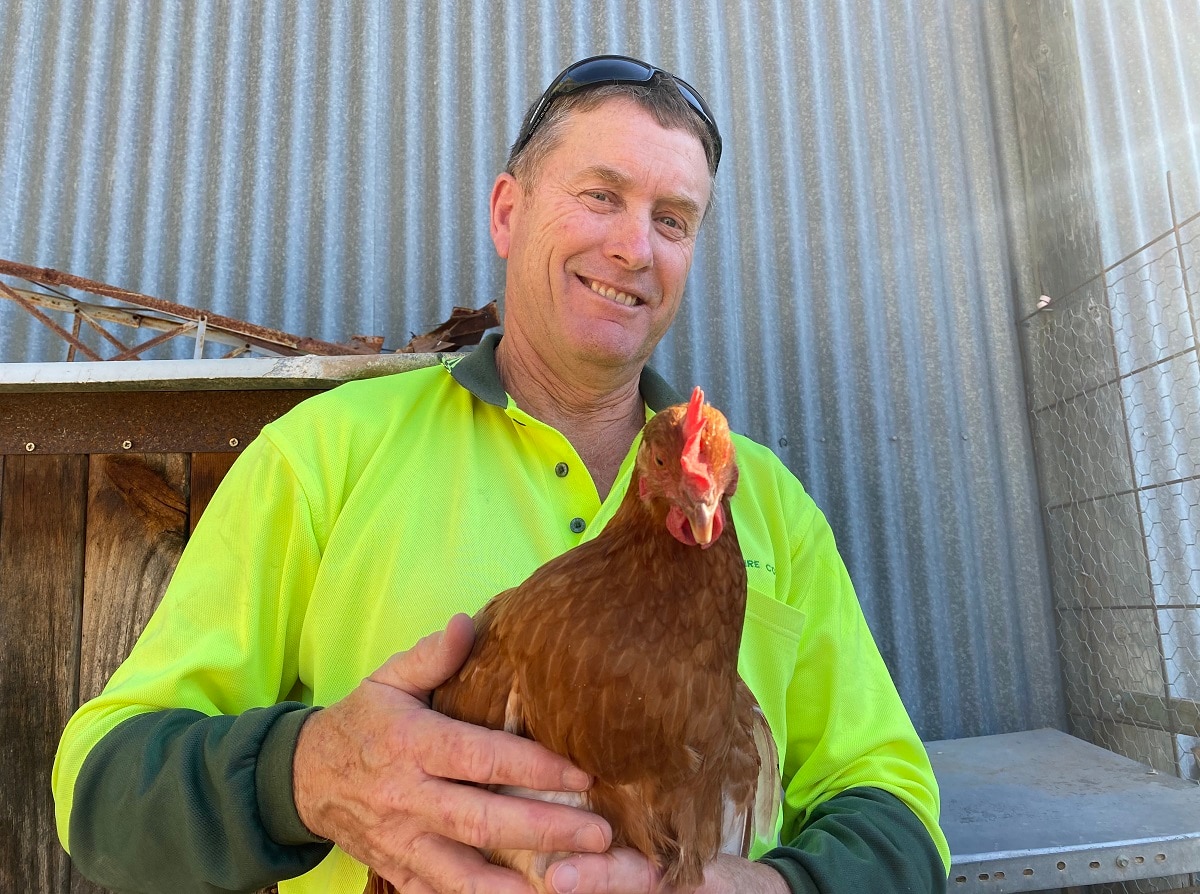 Kevin Rosser from Hay in NSW holding a chicken
