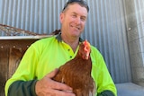 Kevin Rosser from Hay in NSW holding a chicken