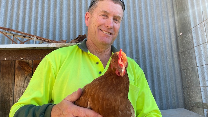 Kevin Rosser from Hay in NSW holding a chicken