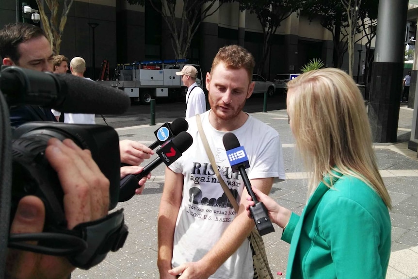Andrew Paine chats with reporters outside court