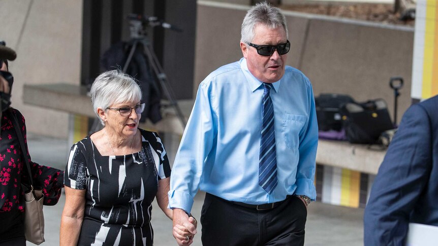 Rae and Colin Betts hold hands as they arrive at court.