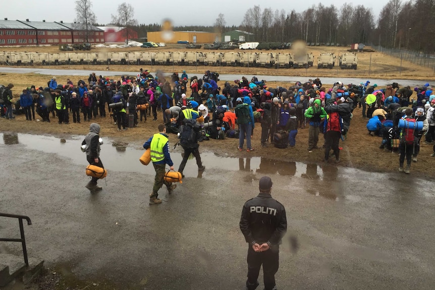 Teenagers wait outside refugee centre