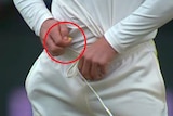 Screengrab of Cameron Bancroft holding a yellow object