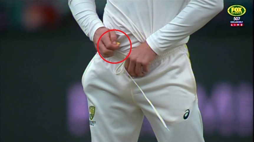 Screengrab of Cameron Bancroft holding a yellow object