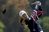 Minjee Lee drives the ball on the fourth hole. She wears a hat, sunglasses and long-sleeve top