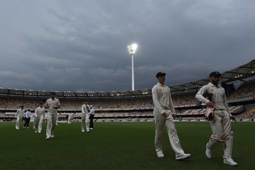 Players trudge off as rain interrupts first Test