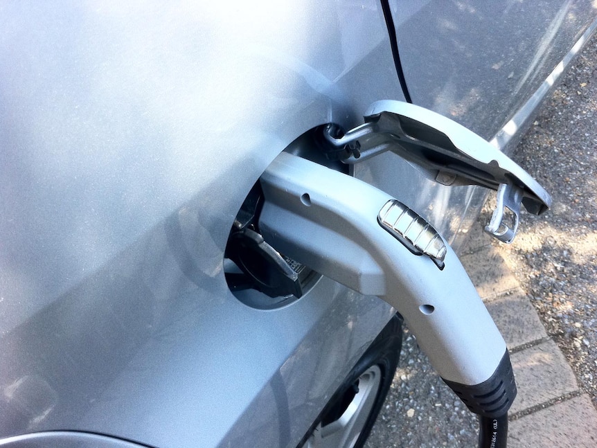 A charger plugged in at a car's charging point.