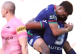 Warriors NRL players embrace as they celebrate a try against the Panthers.