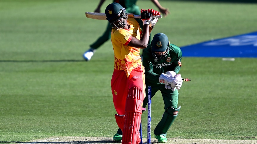 Blessing Muzarabani completes a swing at the ball while Nurul Hasan takes the bails off