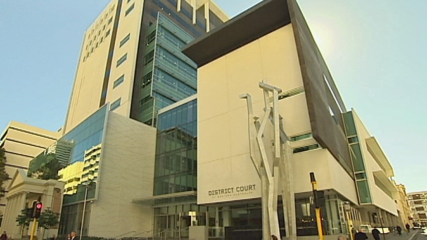 A towering, modern court building with lettering that reads "District Court".