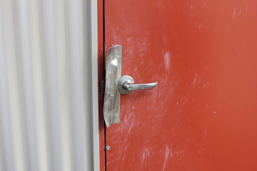 A damaged door at the Snake Valley CFA station, which was broken into over the weekend.