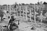 Three young French girls lay tributes at the graves fallen Australian soldiers 