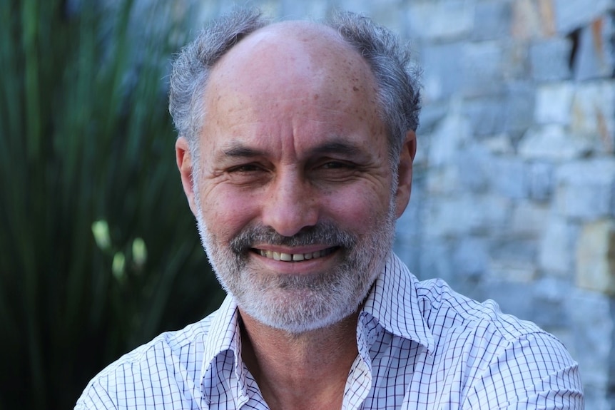 un, hombre, con, corto, pelo gris, y, barba, sonriente, aire libre 