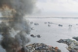 Burning houses swept away in tsunami