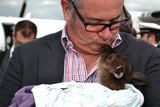 SA Tourism Minister Leon Bignell kisses a kangaroo