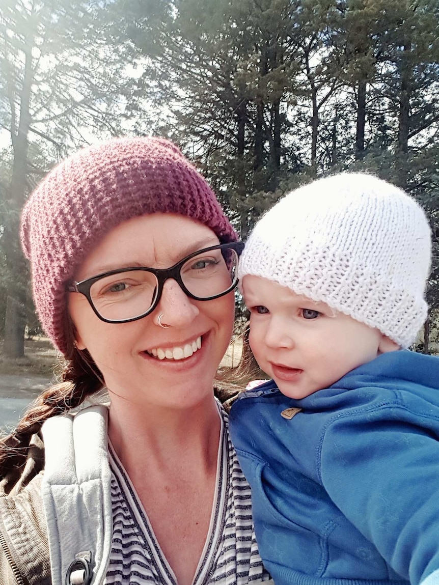 Kiri Joyce-Griggs holds her young son in a park to depict the toughest and most rewarding parts of parenting.