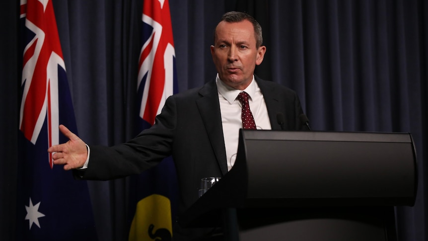 Mark McGowan speaks at a lectern at an official government press conference