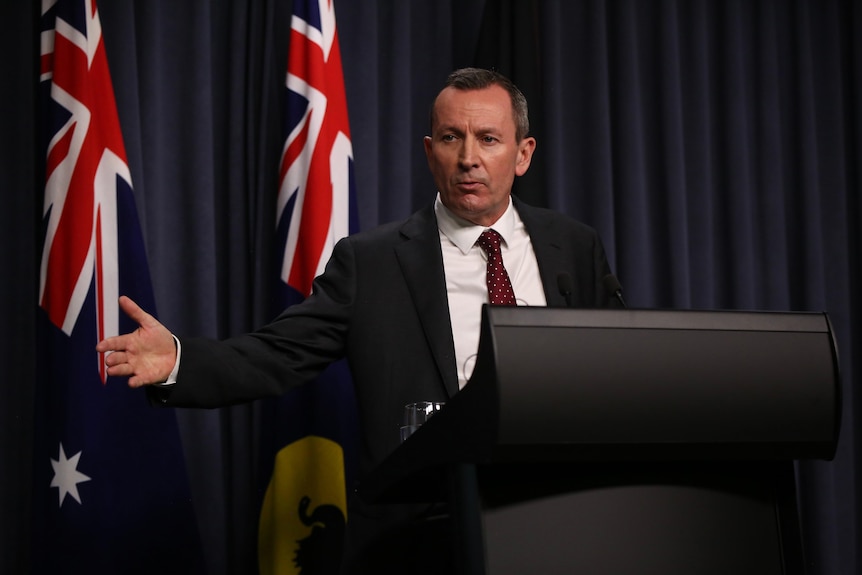 Mark McGowan speaks at a lectern at an official government press conference
