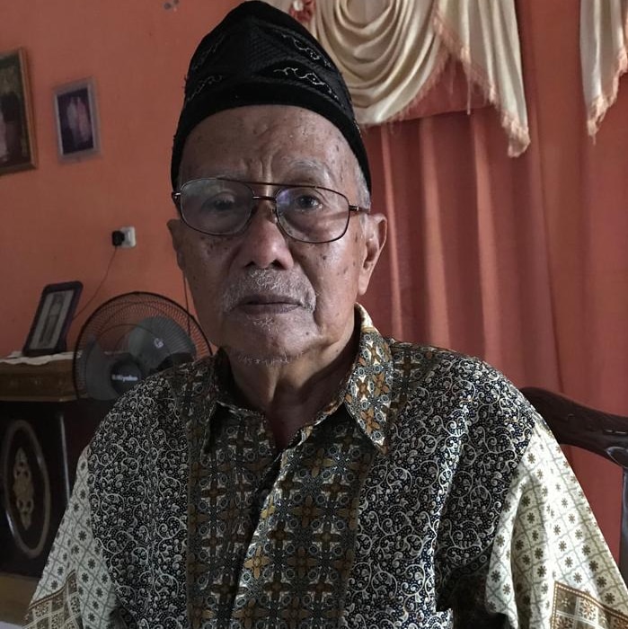 Elderly Indonesian man Andi Monji poses for a photo.