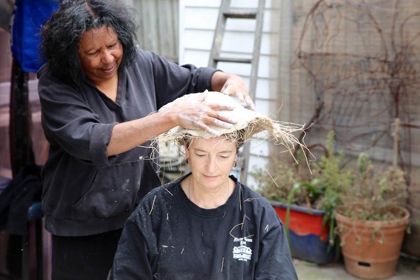 Artist Maree Clarke wears a Kopi hat.