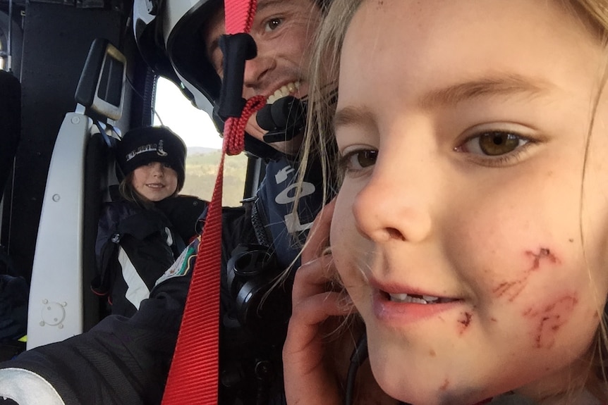 Two girls, who were found after being lost in the bush overnight, in the police helicopter