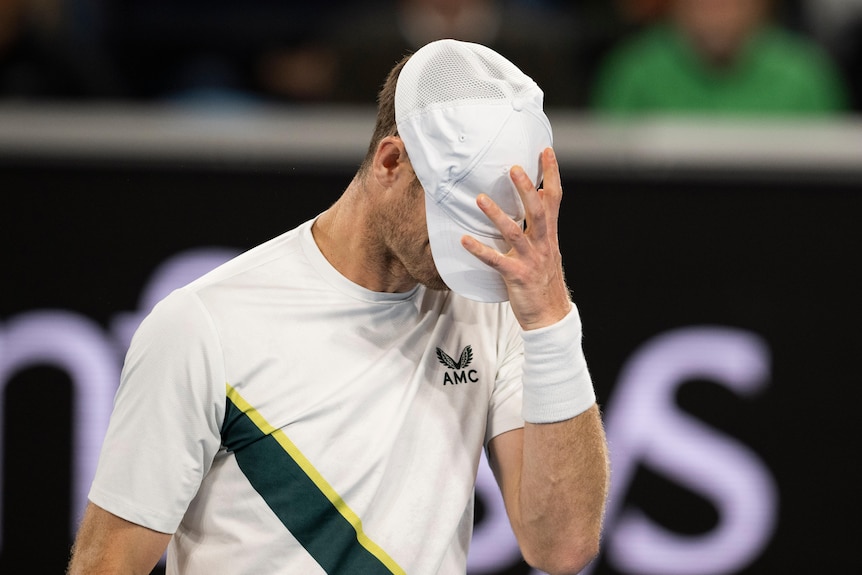 Andy Murray covers his face with his cap