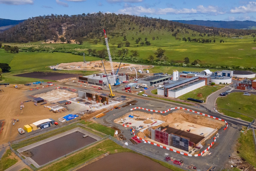 Aerial view of a industrial construction site set among green hills