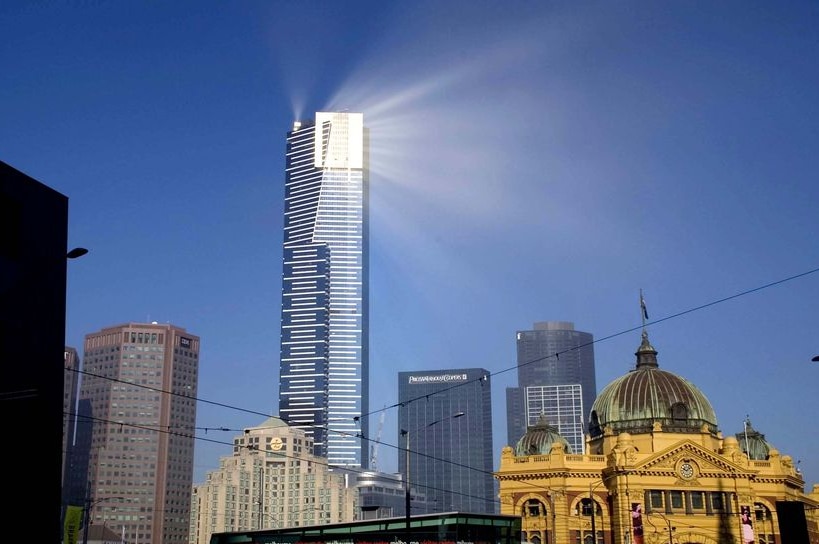 The sun's rays beam off the top of the Eureka Tower
