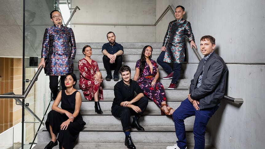 Colour photo of the 2018 Museum of Contemporary Art annual exhibition of young Australian artists posing on concrete stairs.