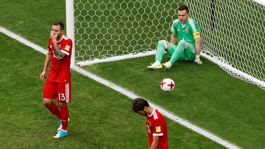 Russia's Fyodor Kudryashov and Igor Akinfeev looks dejected after Mexico's first goal.