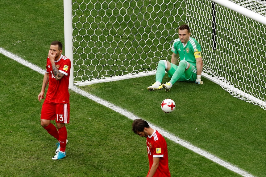 Russia's Fyodor Kudryashov and Igor Akinfeev looks dejected after Mexico's first goal.