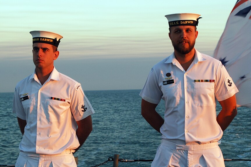 Joshua Scanlon (right) and another crewman on HMAS Darwin