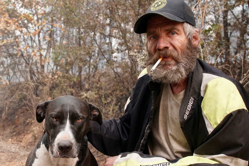 A rugged-looking man with a dog