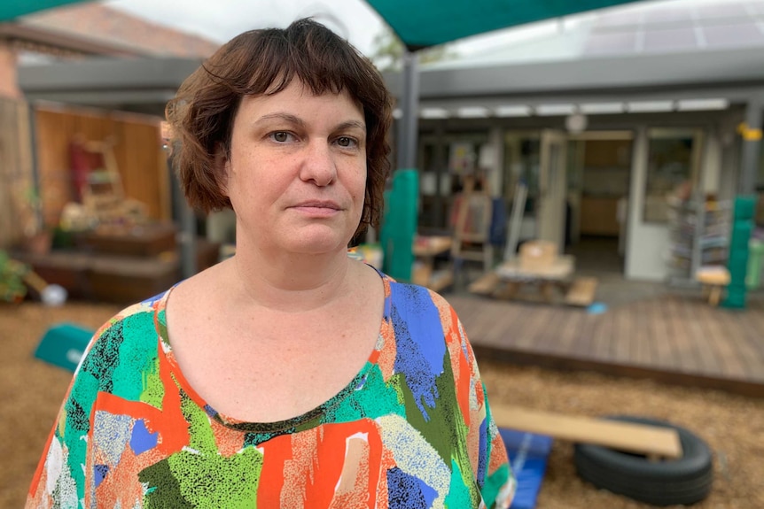 Justine Rouse stands near children's play equipment.