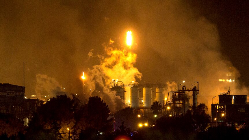 Smoke and flames rising from a Spanish chemical plant after an explosion.