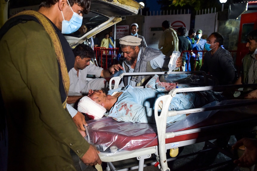 Man on a stretcher arrives at hospital