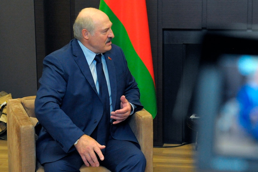 Belarusian President Alexander Lukashenko gestures while talking to Russian President Vladimir Putin