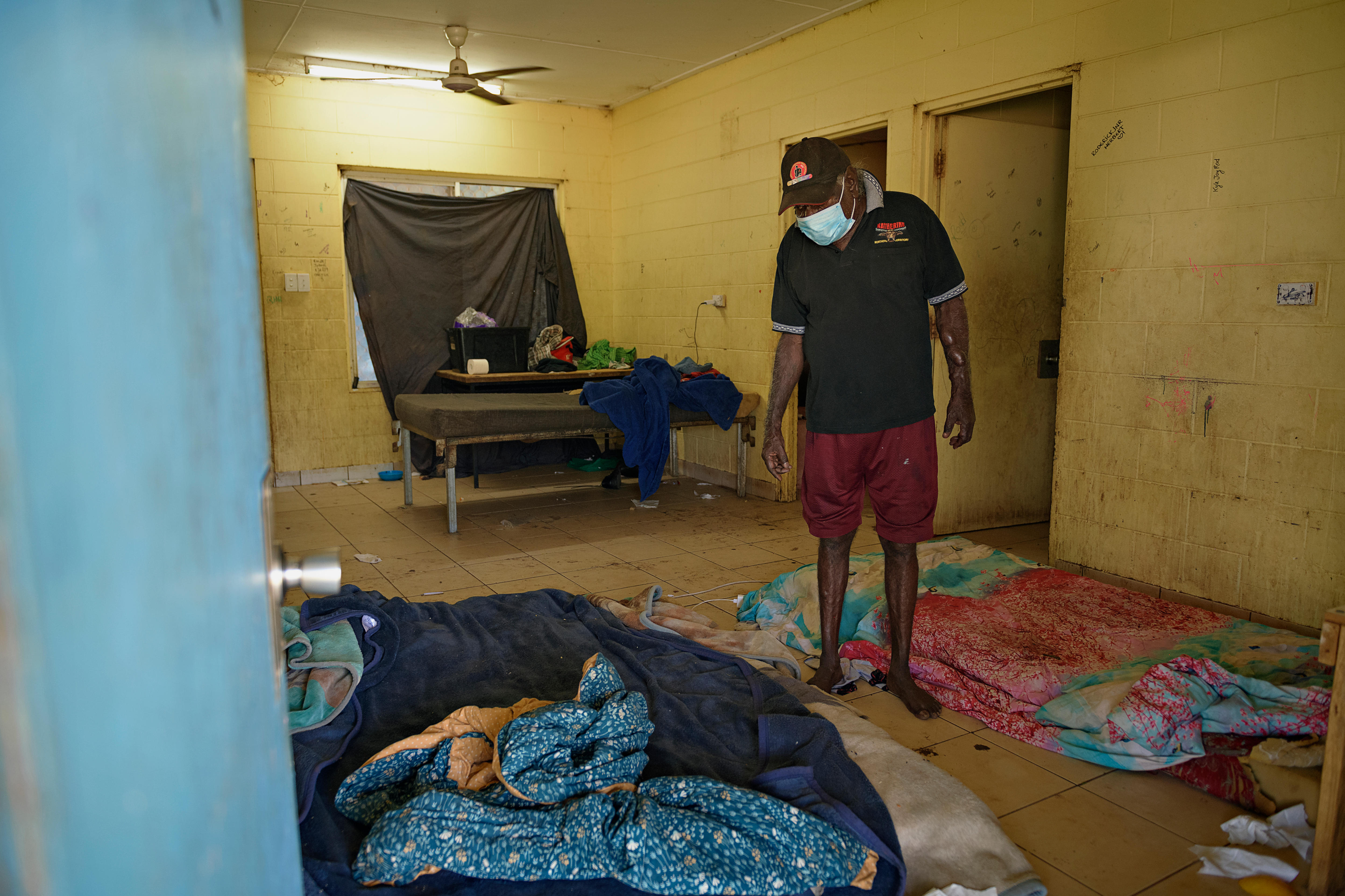 A man stands in his living room in Rockhole. 