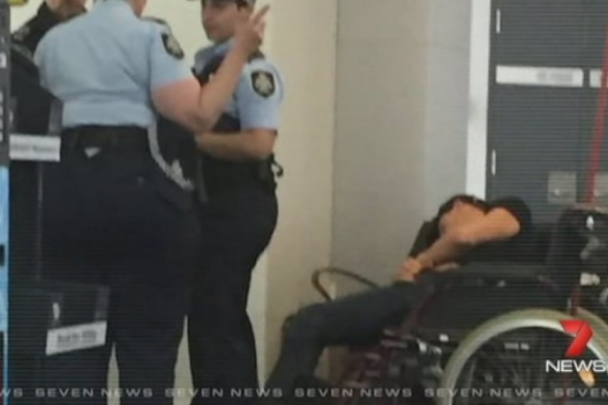 Grant Hackett slumped in wheelchair at Melbourne Airport